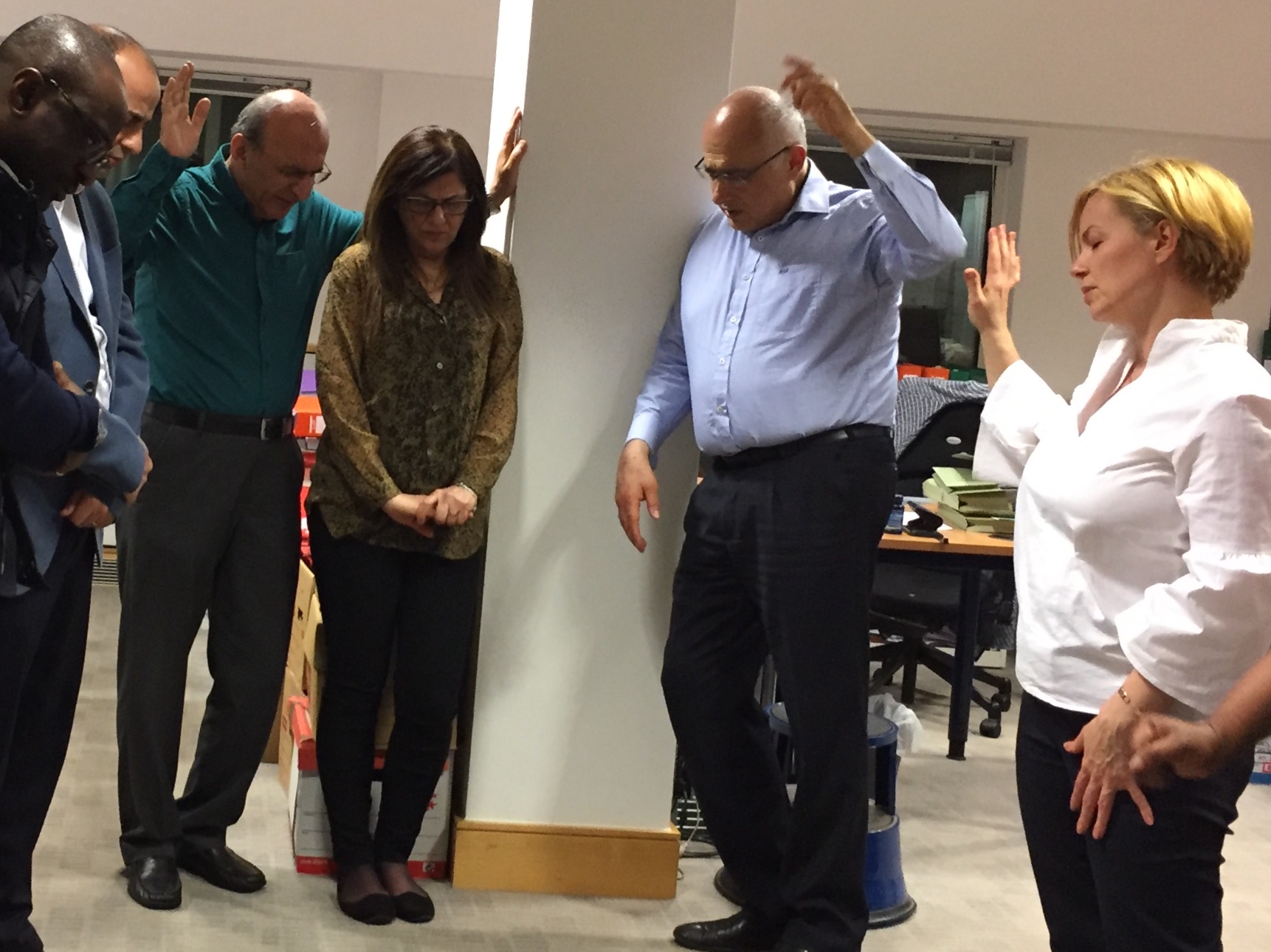 Standing together in a circle of prayer
